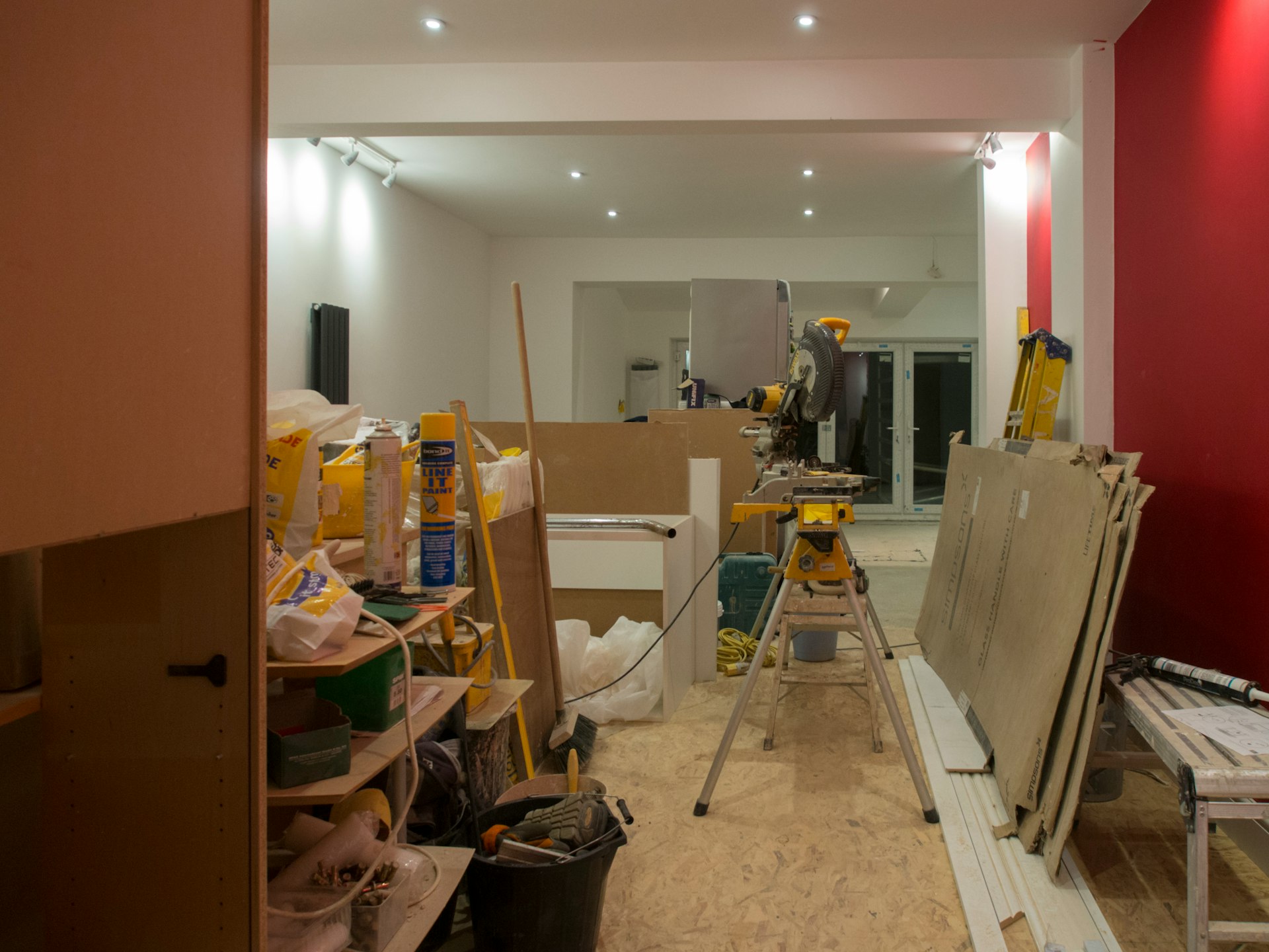 A room that is being remodeled with red walls